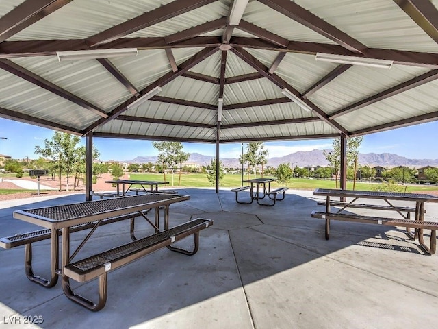 view of property's community with a gazebo, a mountain view, and a patio area