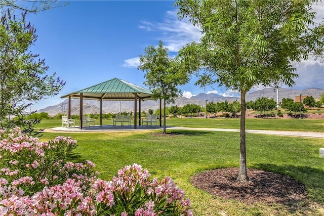 surrounding community featuring a gazebo, a mountain view, and a lawn