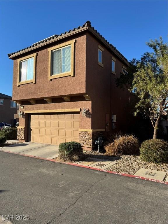 view of side of home with a garage