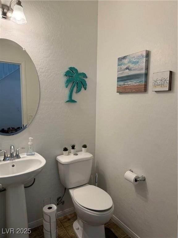 bathroom featuring tile patterned flooring and toilet