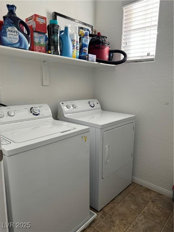 laundry area with tile patterned floors and washing machine and clothes dryer