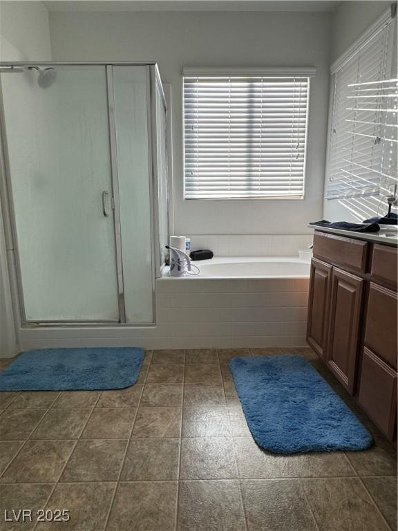 bathroom featuring vanity and plus walk in shower