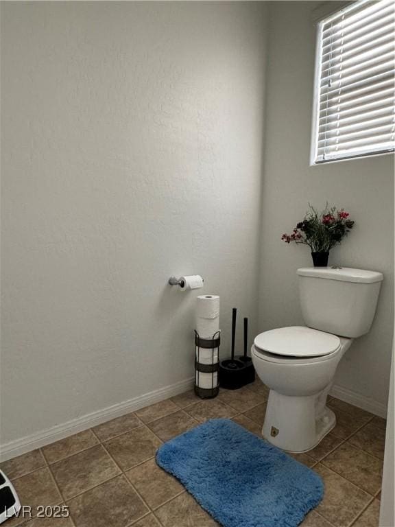 bathroom featuring tile patterned flooring and toilet