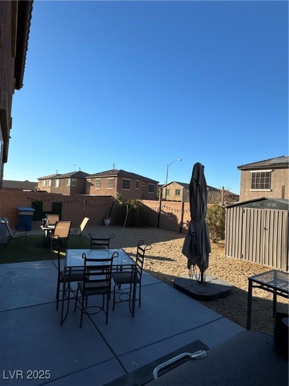 view of patio / terrace featuring a storage shed