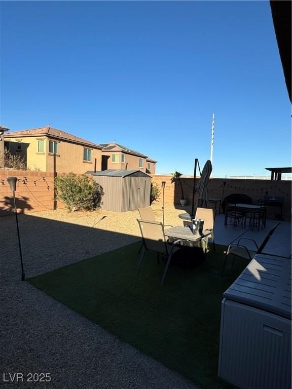 view of yard with a shed and a patio