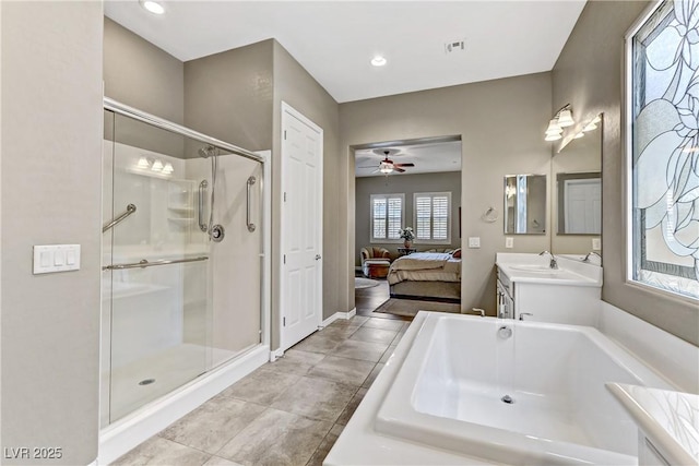 bathroom with plus walk in shower, vanity, and ceiling fan