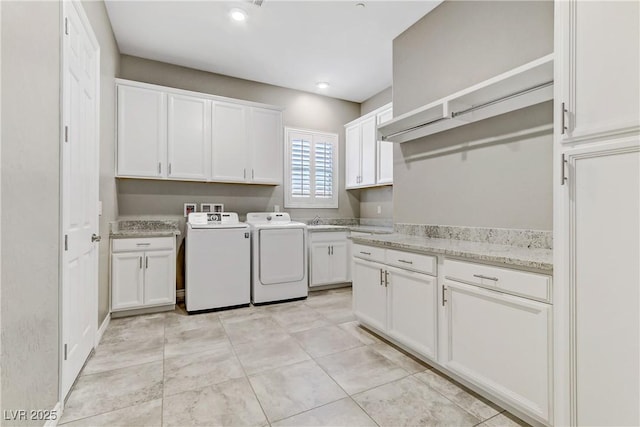 washroom featuring cabinets, independent washer and dryer, sink, and light tile patterned floors