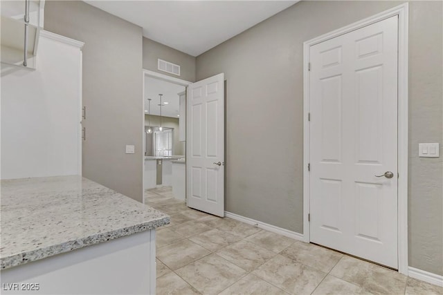 kitchen with light stone countertops and light tile patterned floors