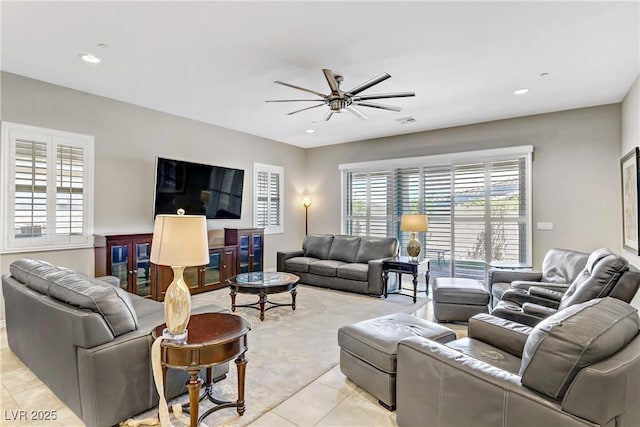 living room with ceiling fan and light tile patterned floors