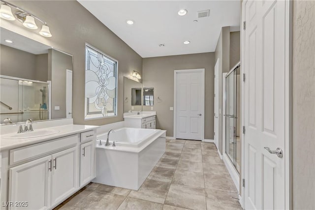 bathroom with tile patterned flooring, vanity, and separate shower and tub