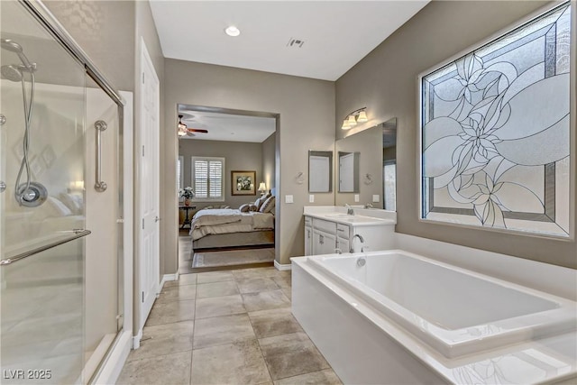 bathroom with plus walk in shower, vanity, and ceiling fan