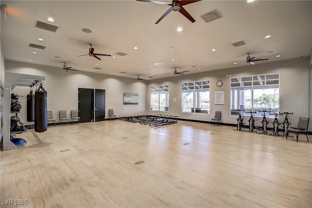 exercise room featuring plenty of natural light and light wood-type flooring