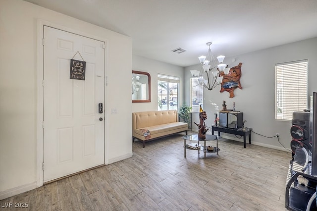 foyer featuring a chandelier and light hardwood / wood-style floors