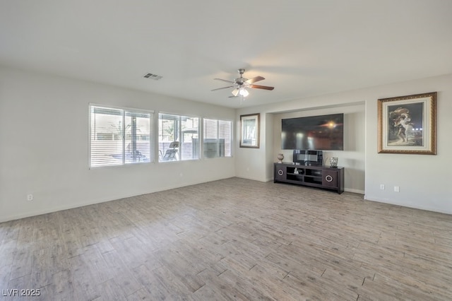 unfurnished living room with ceiling fan and light hardwood / wood-style flooring