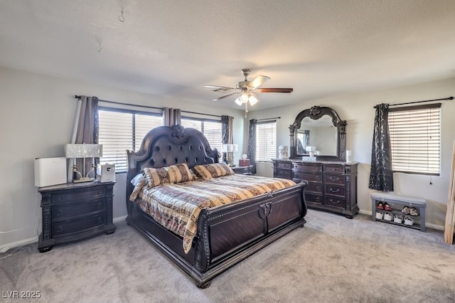 carpeted bedroom featuring a textured ceiling and ceiling fan