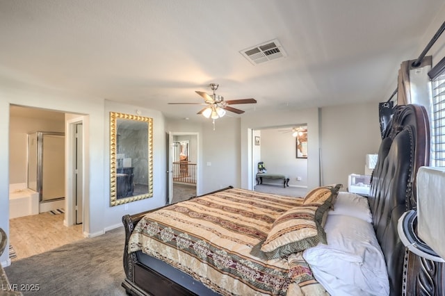 bedroom with carpet flooring, ceiling fan, and connected bathroom