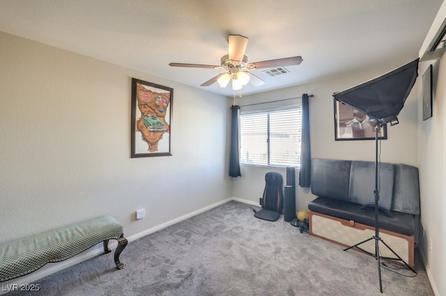 sitting room featuring ceiling fan and carpet floors