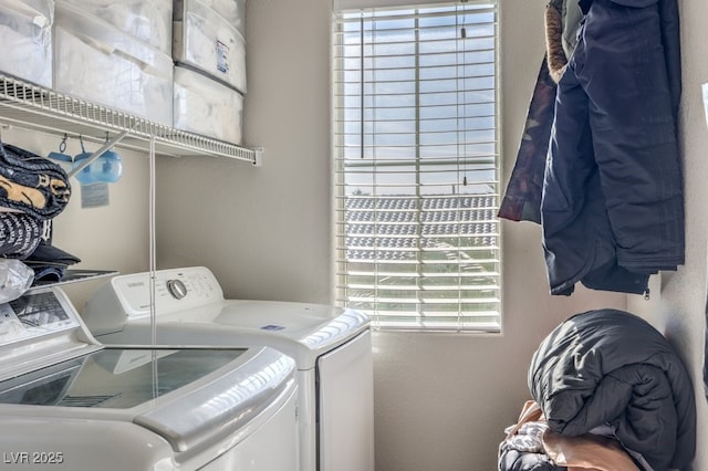 laundry area with plenty of natural light and separate washer and dryer