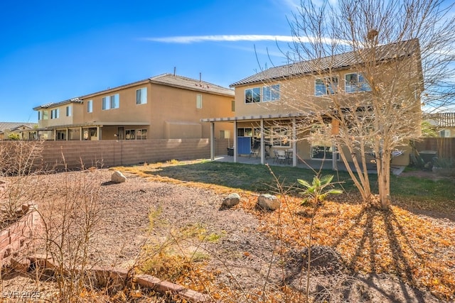 back of property featuring a patio and a pergola