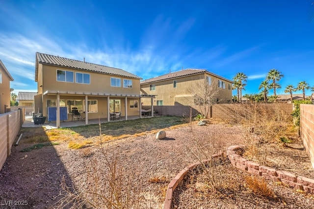 back of property featuring a patio