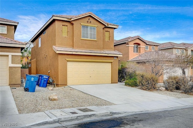 view of front of property featuring stucco siding, a tiled roof, concrete driveway, and a garage