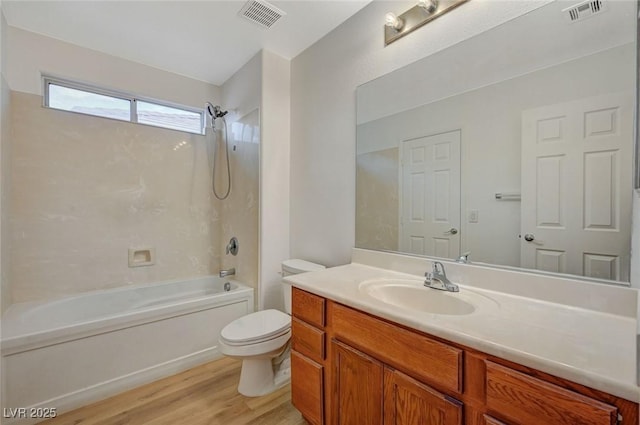 full bath with bathing tub / shower combination, toilet, wood finished floors, and visible vents