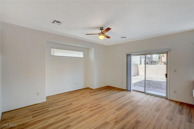 unfurnished room featuring visible vents, a ceiling fan, light wood-type flooring, and baseboards