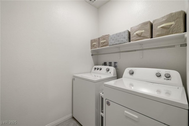 clothes washing area with washing machine and clothes dryer