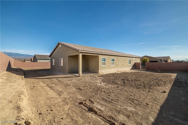 back of house featuring a mountain view