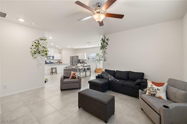 living room featuring light tile patterned flooring and ceiling fan