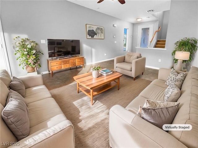 living room featuring concrete flooring and ceiling fan