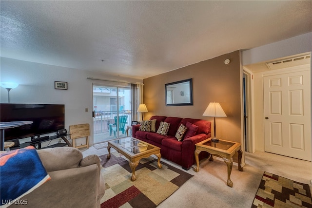 carpeted living room with a textured ceiling