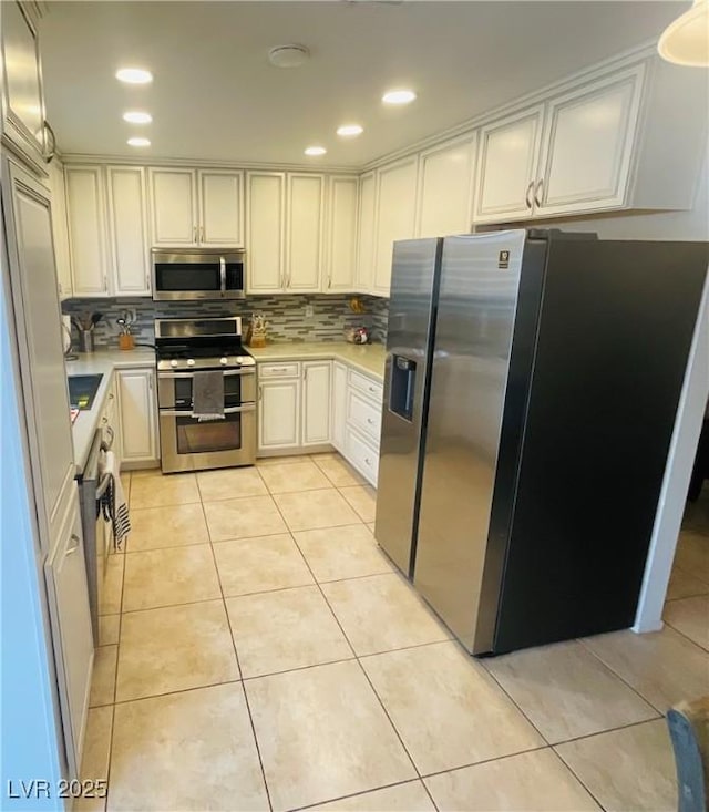 kitchen featuring tasteful backsplash, light tile patterned flooring, and stainless steel appliances