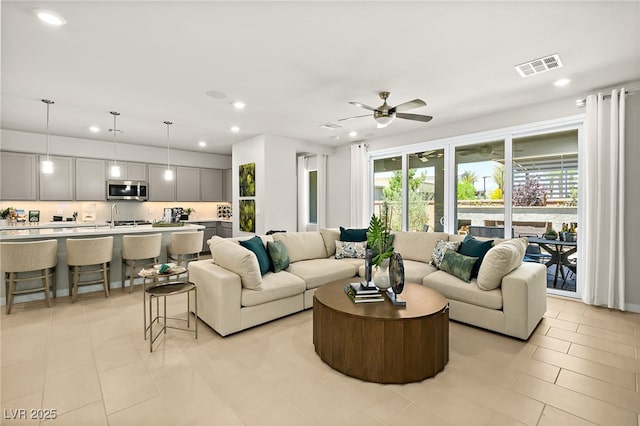 tiled living room with ceiling fan