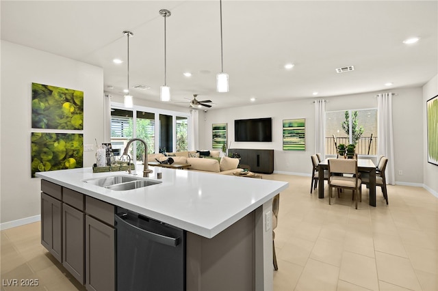 kitchen with dishwasher, sink, ceiling fan, and an island with sink