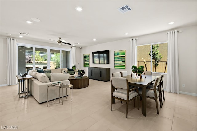 tiled dining area with plenty of natural light and ceiling fan