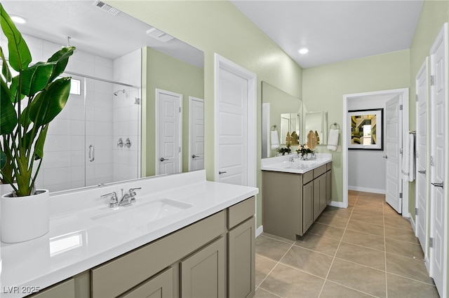 bathroom featuring tile patterned flooring, vanity, and walk in shower