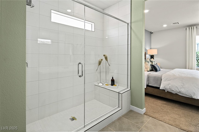 bathroom with tile patterned flooring and an enclosed shower