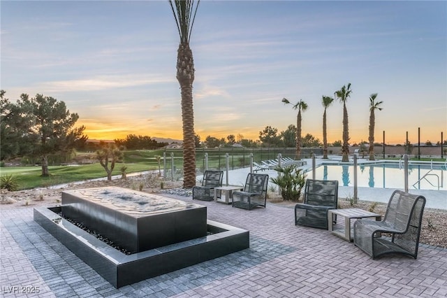 patio terrace at dusk with a community pool