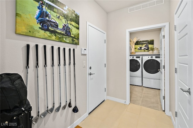 laundry room with light tile patterned floors and separate washer and dryer