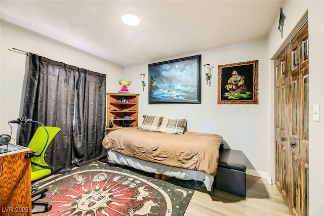 bedroom with a closet and hardwood / wood-style floors