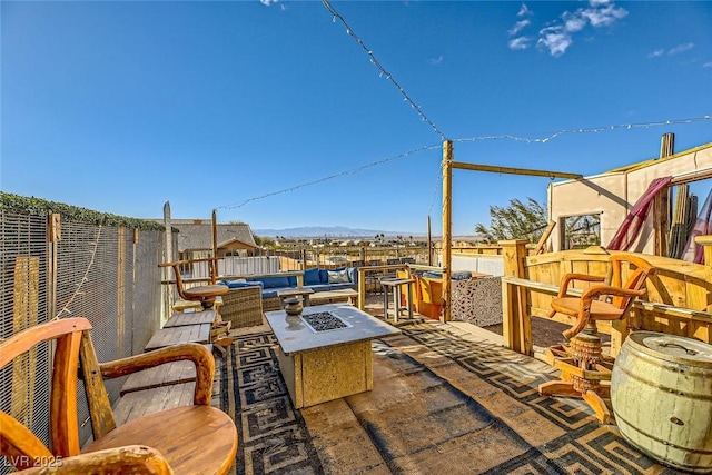 view of patio / terrace with a mountain view and an outdoor fire pit