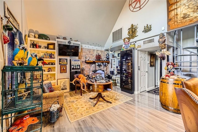 interior space featuring hardwood / wood-style flooring and high vaulted ceiling