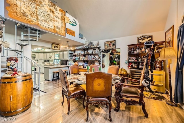 dining area featuring light hardwood / wood-style floors and vaulted ceiling