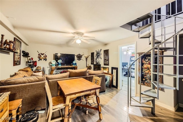 living room with ceiling fan and wood-type flooring