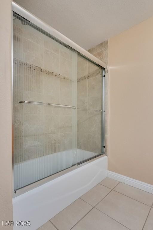 bathroom featuring tile patterned floors and combined bath / shower with glass door