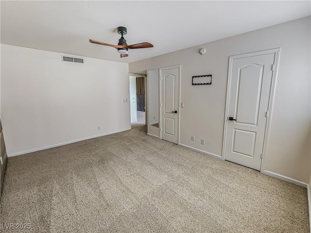 spare room with ceiling fan and carpet floors