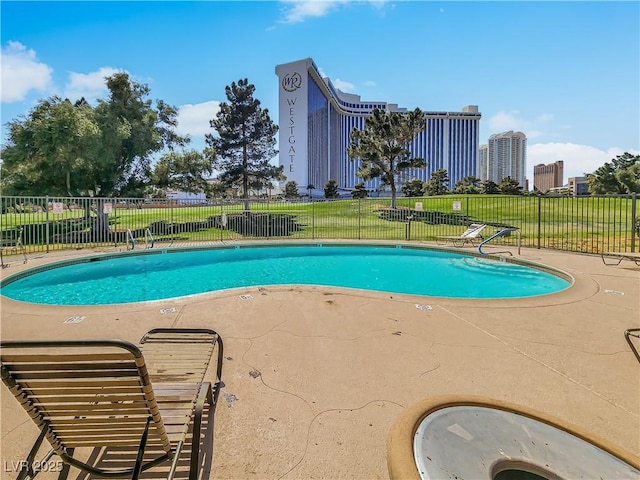 view of pool featuring a yard and a patio