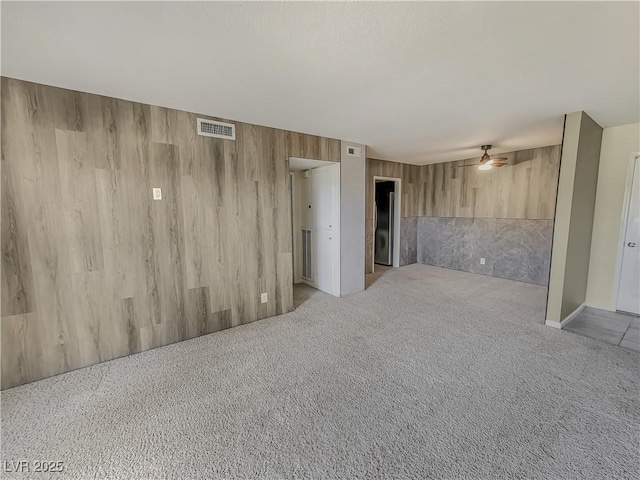 unfurnished room with ceiling fan and light colored carpet