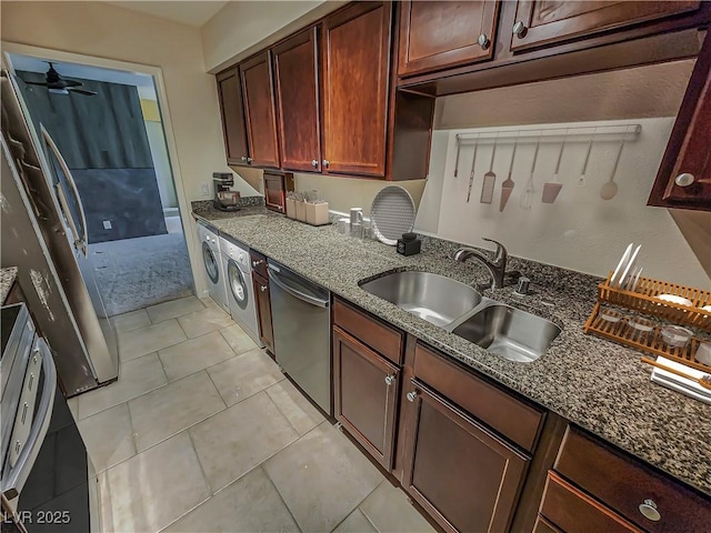 kitchen with ceiling fan, sink, stainless steel dishwasher, dark stone counters, and light tile patterned floors